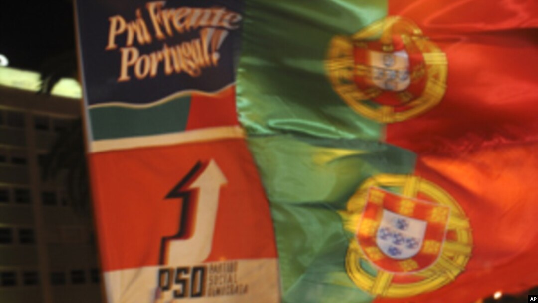 A supporter of the center-right Social Democratic Party, PSD, celebrates in the street in Lisbon after his party won Portugal's general elections Sunday, June 5 2011.