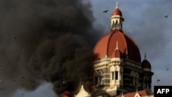 This file photograph taken on 27 Nov 2008 shows flames gushing out of The Taj Mahal Hotel in Mumbai.