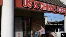 A woman wears a mask in Alhambra, Calif., Jan. 31, 2020. As China grapples with the coronavirus outbreak, Chinese people in the Los Angeles area are encountering a cultural disconnect.