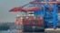 FILE - A container ship is loaded at the harbor in Hamburg, Germany, Oct. 15, 2018.