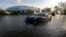 A car sits in a flooded parking lot outside the Germain Arena, which was used as an evacuation shelter for Hurricane Irma, which passed through yesterday, in Estero, Fla., Sept. 11, 2017. 