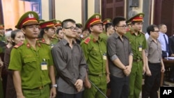 Members of the Provisional Central Government of Vietnam in exile in the United States stand trial in Ho Chi Minh City, Vietnam, Aug. 21, 2018. (Vietnam News Agency/Thanh Chung via AP) 
