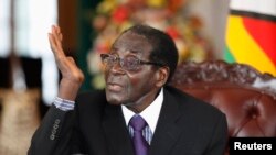 FILE: Robert Mugabe holds a news conference after the swearing-in of ministers at the State House in Harare, Sept. 11, 2013. 