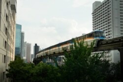 A monorail runs between buildings ahead of the 2020 Summer Olympics, Wednesday, July 14, 2021, in Tokyo. The state of emergency will be in effect throughout the entire duration of the Olympics, which open on July 23.