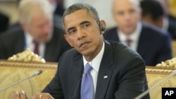 President Barack Obama listens as Russian President Vladimir Putin speaks during the start of the G-20 Working Session at the Konstantin Palace in St. Petersburg, Russia, Sept. 5, 2013.