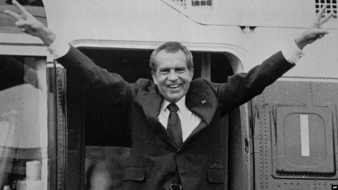 Richard Nixon says goodbye to members of his staff outside the White House as he boards a helicopter for Andrews Air Force Base after resigning the presidency on August 9, 1974.