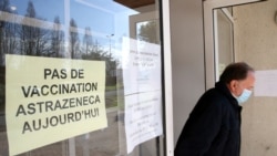 A man leaves a vaccination site with a sign reading "No vaccination with the AstraZeneca vaccine today," in Saint-Jean-de-Luz, southwestern France, March 16, 2021.