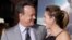 FILE - Actor Tom Hanks poses with wife, actress Rita Wilson, as they arrive for a film premiere in Hollywood, Oct. 24, 2012.
