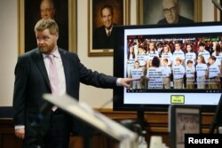وکیل والدین قربانیان سندی هوک عکس کودکان کشته شده را در جریان محاکمه الکس جونز در آستین نشان می‌دهد