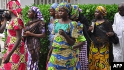 Schoolgirls, who escaped from Boko Haram kidnappers in the village of Chibok, arrive at the Government house to speak with State Governor Kashim Shettima, in Maiduguri, Nigeria, June 2, 2014.