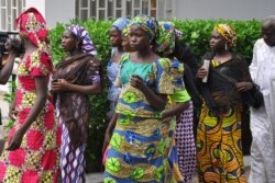 FILE - Schoolgirls, who escaped from Boko Haram kidnappers in the village of Chibok, arrive at the Government house to speak with State Governor Kashim Shettima, in Maiduguri, Nigeria, June 2, 2014.