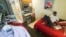 Jon-Christian Stubblefield relaxes inside of his 200 square foot Mini-Suite apartment in the First Hill neighborhood in Seattle, Washington May 12, 2013.