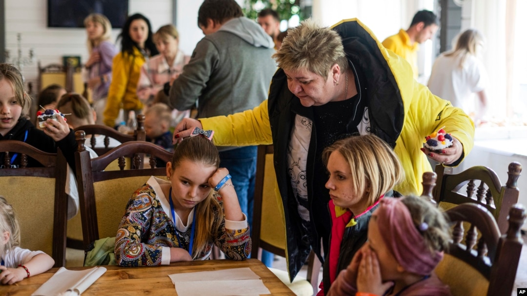 FILE - Nina Poliakova speaks to her foster daughter Olha Hinkina at a recovery camp for children and their mothers affected by the war, near Lviv, Ukraine, on May 3, 2023.