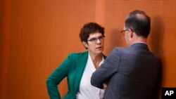 Christian Democratic Union party chairwoman and Defense Minister Annegret Kramp-Karrenbauer talks with Foreign Minister Heiko Maas prior to the weekly cabinet at the chancellery in Berlin, Feb. 12, 2020. 