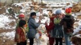Syrian refugees children play near a snowman in a camp for Syrians who fled their country&rsquo;s civil war, in the Bekaa valley, eastern Lebanon. 