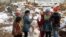 Syrian refugees children play near a snowman in a camp for Syrians who fled their country&rsquo;s civil war, in the Bekaa valley, eastern Lebanon. 