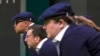 FILE - Line judges concentrate during a first round men's singles match on day three of the Wimbledon tennis championships in London, July 5, 2023. Humans will be replaced by artificial intelligence to make the calls beginning in 2025. 