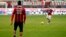 AC Milan's Kevin Prince Boateng (L), wearing a jersey against racism, and Stephan El Shaarawy warm up before their match against Siena in Milan Jan. 6, 2013.