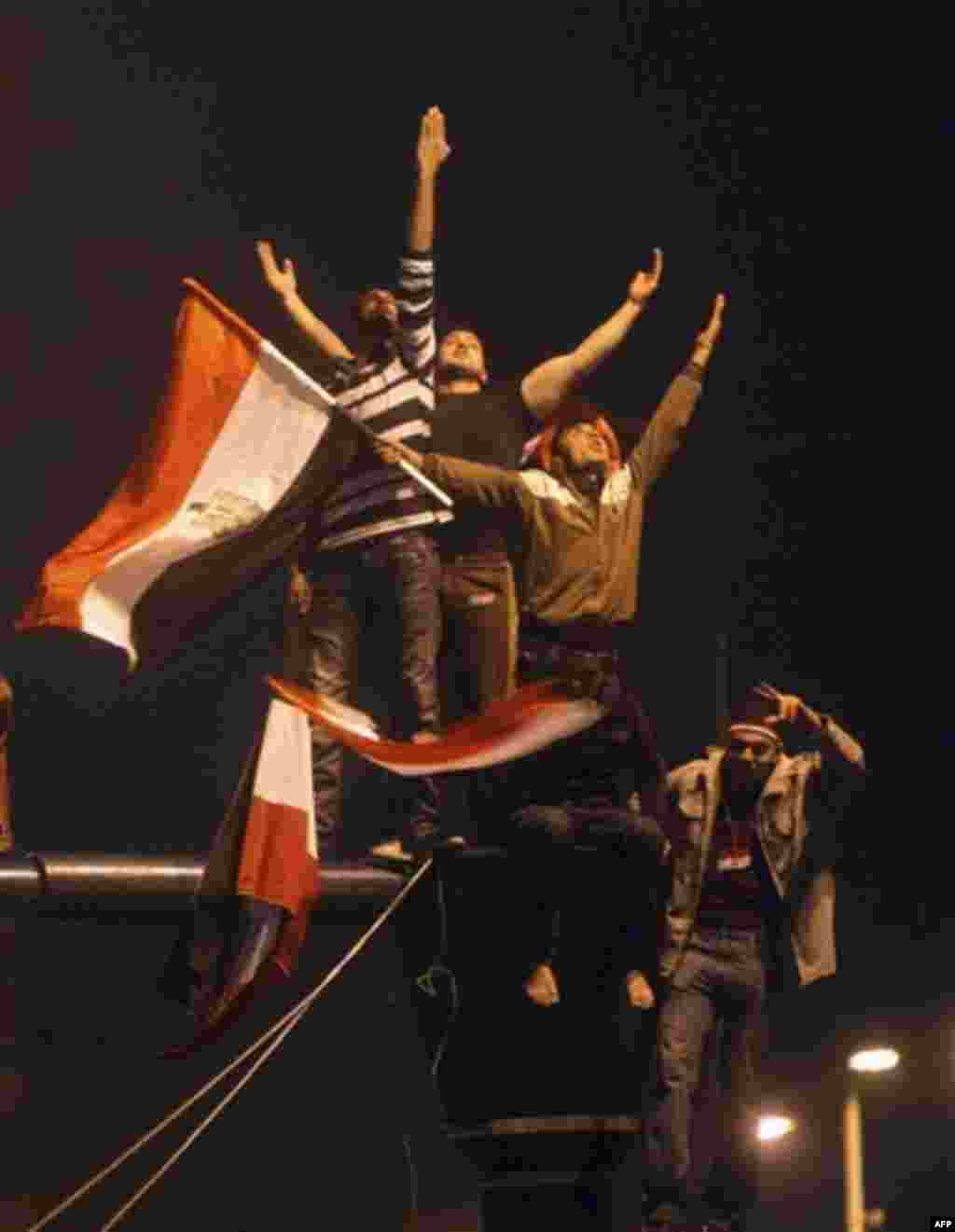 Egyptians celebrate in Tahrir Square after President Hosni Mubarak resigned and handed power to the military in Cairo, Egypt, Friday, Feb. 11, 2011. Egypt exploded with joy, tears, and relief after pro-democracy protesters brought down President Hosni Mub