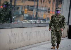 A U.S. military personnel wearing a face mask walks outside the Jacob K. Javits Convention Center, which was converted into a hospital during the outbreak of the coronavirus disease (COVID-19), in New York City, April 27, 2020.
