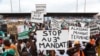 Supporters of Ivory Coast's Coast opposition coalition parties hold signs during a rally to protest against president Alassane Ouattara's bid for a third term in Abidjan, Ivory Coast, Oct. 10, 2020.