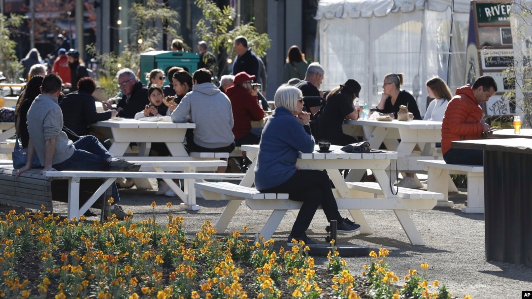 Patrons enjoy lunch at a market in Christchurch, New Zealand, Aug. 9, 2020, as the country marked 100 days of being free from the coronavirus, with just a few infections continuing to be picked up at ports of entry where people are quarantined.