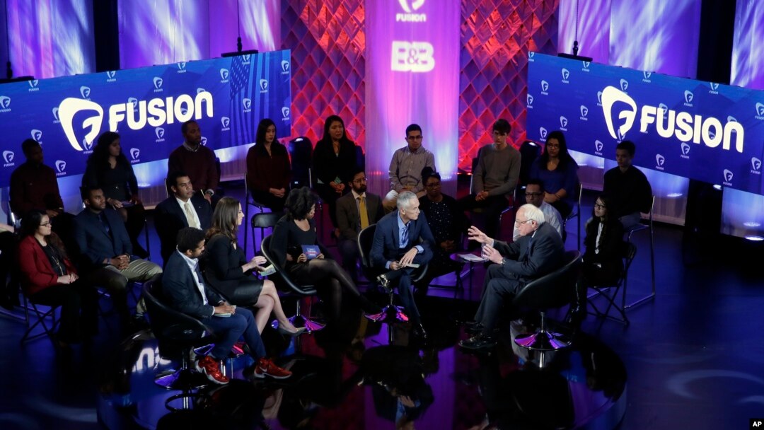 Democratic presidential candidate, Senator Bernie Sanders (right, with raised arms), talks during the Brown & Black Forum, Jan. 11, 2016, in Des Moines, Iowa. 