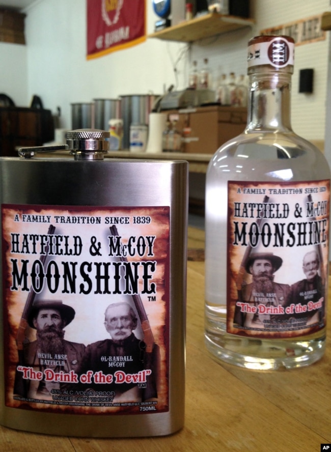 FILE - A flask and bottle are shown Jan. 22, 2015, at the Hatfield & McCoy Moonshine distillery in Gilbert, W.Va. Direct descendants of the Hatfields and McCoys. (AP Photo/John Raby)