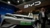 FILE - A model poses near the BYD Song L EV car during Auto China 2024 held in Beijing, April 25, 2024. 