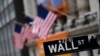 FILE - A sign for Wall Street is seen in front of the New York Stock Exchange, in New York City, Jan. 31, 2020.