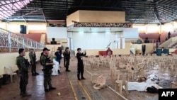 This handout photo taken on Dec. 3, 2023 and released via the Lanao Del Sur Provincial Information Office's Facebook page shows police inspecting the site of a bomb attack inside a gymnasium at Mindanao State University in Marawi, Philippines. 