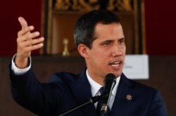 Venezuelan opposition leader Juan Guaido, who many nations have recognized as the country's rightful interim ruler, gestures as he speaks during a session of Venezuela's National Assembly at a public square in Caracas, July 23, 2019..