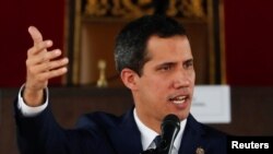 Venezuelan opposition leader Juan Guaido, who many nations have recognized as the country's rightful interim ruler, gestures as he speaks during a session of Venezuela's National Assembly at a public square in Caracas, July 23, 2019..