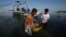Filipino fishermen bring their fish to shore in the coastal town of Infanta, Pangasinan province, northwestern Philippines, May, 7, 2013.