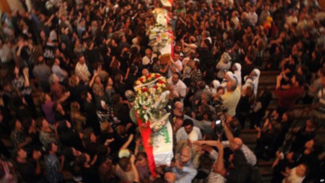 Mourners carry the coffins of slain Christians during their funeral in Baghdad, Iraq, Tuesday, Nov. 2, 2010. The victims were killed Sunday when gunmen stormed a church during mass and took the entire congregation hostage.