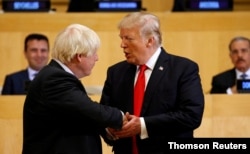 FILE - U.S. President Donald Trump shakes hands with Boris Johnson, left, then the British foreign secretary, as they take part in a session on reforming the United Nations at U.N. Headquarters in New York, Sept. 18, 2017.