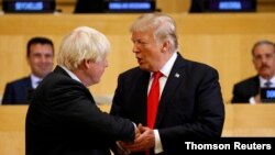 FILE - U.S. President Donald Trump shakes hands with Boris Johnson, left, then the British foreign secretary, as they take part in a session on reforming the United Nations at U.N. Headquarters in New York, Sept. 18, 2017.