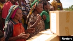 FILE - Residents receive aid after an earthquake in Papua New Guinea in this image released March 7, 2018, by MAF International.