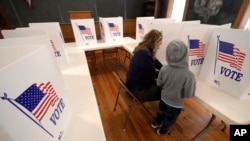 Aliza Bidinger está acompañada por su hijo Jayce, de 6 años, mientras vota en la escuela Buck Creek, de 146 años de antigüedad, el día de las elecciones, el martes 5 de noviembre de 2024, en la zona rural de Perry, Kansas.