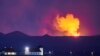 Bessastadir, the official residence of the President of Iceland is seen with the glow from the lava coming out of a fissure near the Fagradalsfjall on the Reykjanes Peninsula behind.