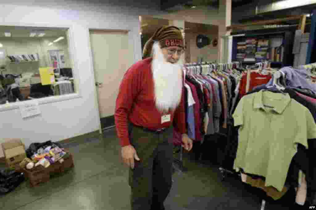 Robert Roszkowski, costumed as a Christmas elf, volunteers in the used clothes area at Sacred Heart Community Service in San Jose, Calif., Wednesday, Dec. 22, 2010. The center is providing some 20, 0000 toys to 5,000 low-income families for the holidays. 