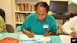 Mr. Peter Ouch, a Cambodian survivor of the Khmer Rouge regime, takes part in an art project that is designed to help survivors deal with trauma, in Santa Ana, California on April 28, 2011. 