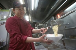 Chef Hung cooks pineapple beef noodle at his restaurant in Taipei, Taiwan, March 10, 2021.