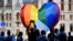 FILE People gather in front of a huge rainbow balloon put up by members of Amnesty International and Hatter, an NGO promoting LGBT rights, at Hungary's parliament in Budapest, Hungary, July 8, 2021.