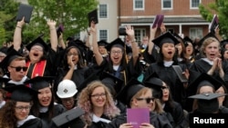 FILE - Graduating seniors react during Commencement ceremonies at Smith College in Northampton, Massachusetts, May 21, 2017