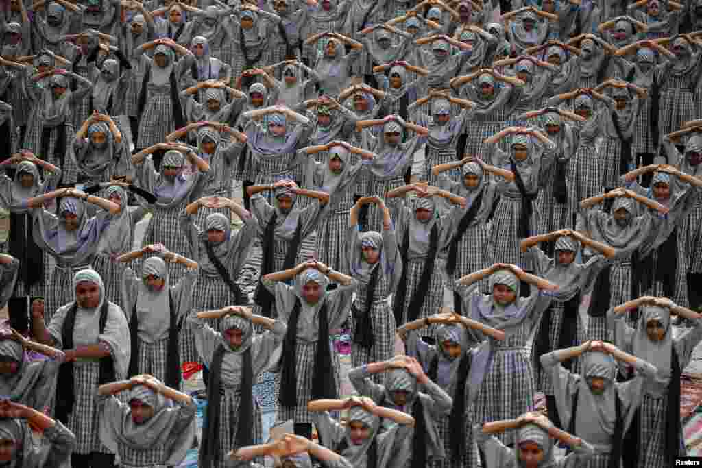 Muslim students attend a yoga lesson at a school ahead of International Yoga Day in Ahmedabad, India.