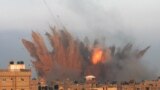 A ball of fire is seen following an Israeli air strike in Rafah, in the southern Gaza Strip. Israeli warplanes kept up deadly raids on Gaza but failed to stop Palestinian militants firing rockets across the border, as the U.S. offered to help negotiate a truce.