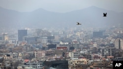 Birds fly over the city of Kabul, Afghanistan, Jan. 31, 2021. 