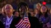 FILE - Superdelegate Margie Woods of Will County, Ill., listens to Michelle Obama, wife of then-Democratic presidential candidate Barack Obama, speak during the Democratic National Convention in Denver, Aug. 25, 2008.