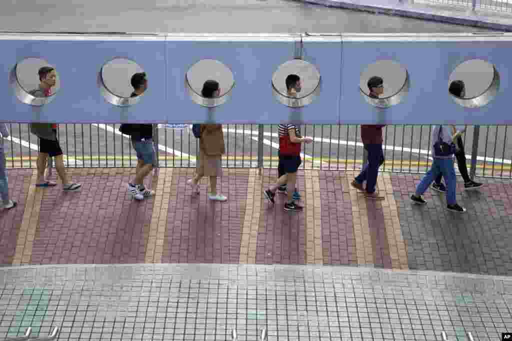 People line up to vote outside of a polling place in Hong Kong.